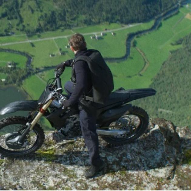Man on a motorcycle on a cliff