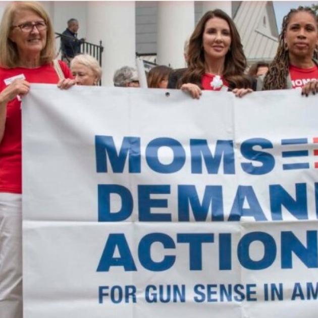 Women holding Moms Demand Action banner