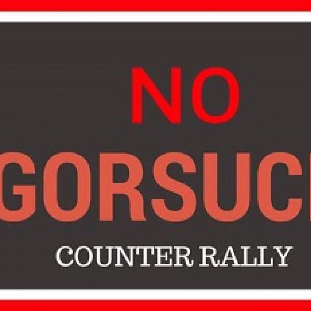 Red words on black saying No Gorsuch counter rally