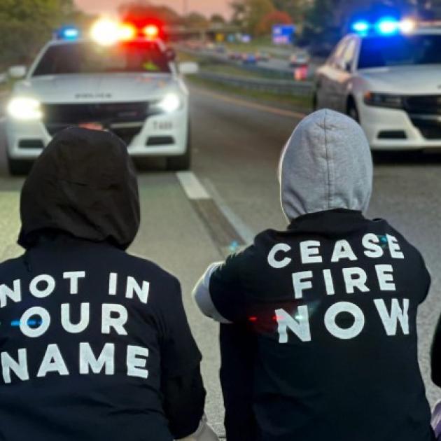 People protesting blocking police cars