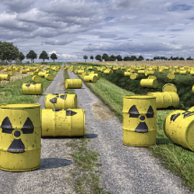 Barrels with radioactive symbols on the ground