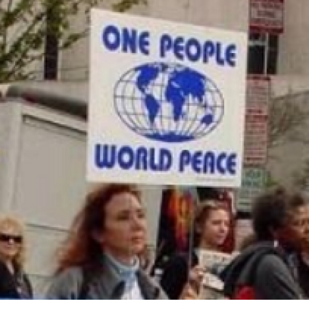 Woman holding sign saying One People World Peace
