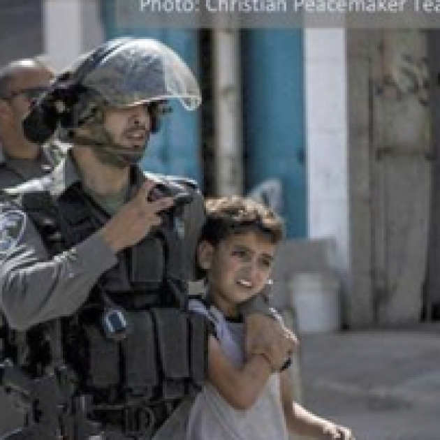 Heavily armed cop grabbing a very young child