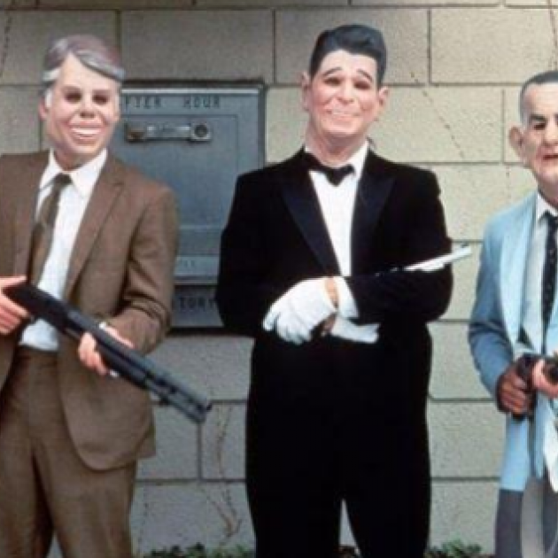 People dressed as presidents in masks with guns