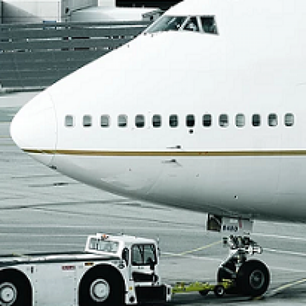 Nose of a jet with a truck next to it