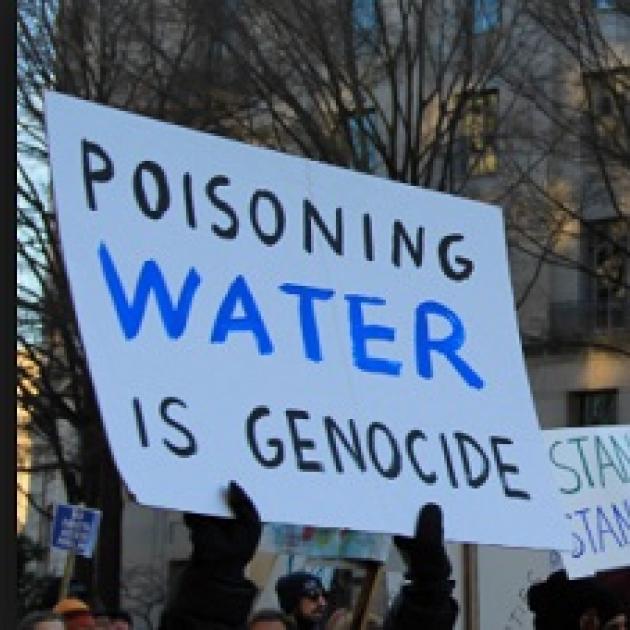 Sign saying Poisoning water is genocide