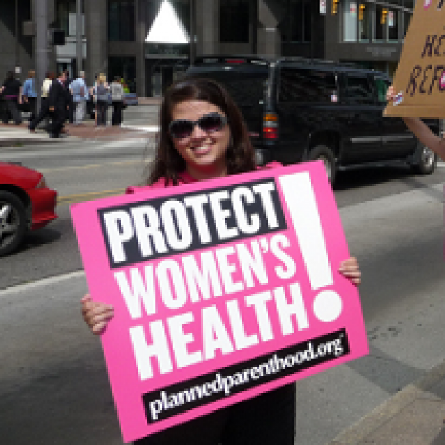 Woman holding sign that says Protect Women's Health