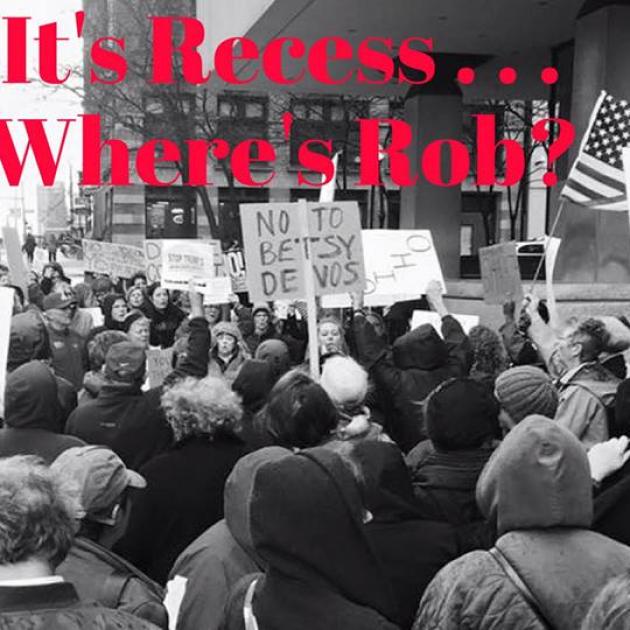 Black and white photo of people at a rally downtown with words It's Recess...Where's Rob?
