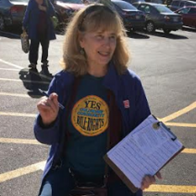 Blonde woman in blue t-shirt with a clipboard