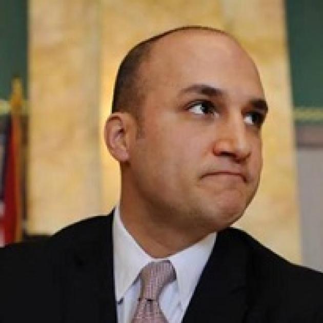 Balding white man in a suit looking determined