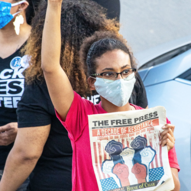 Women at protest holding Free Press