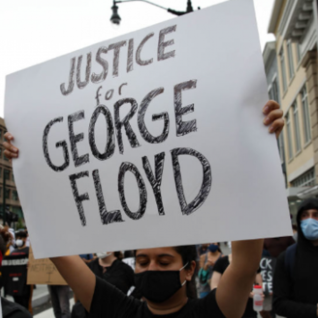 Protester holding sign saying Justice for George Floyd