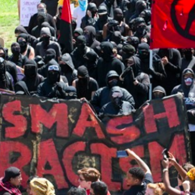 People outside with Smash Racism sign