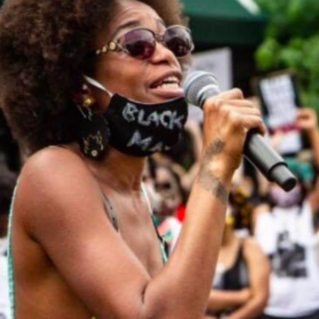 Black woman speaking into a mic