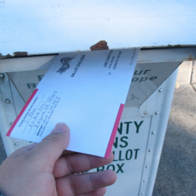 Hand putting mail in mailbox