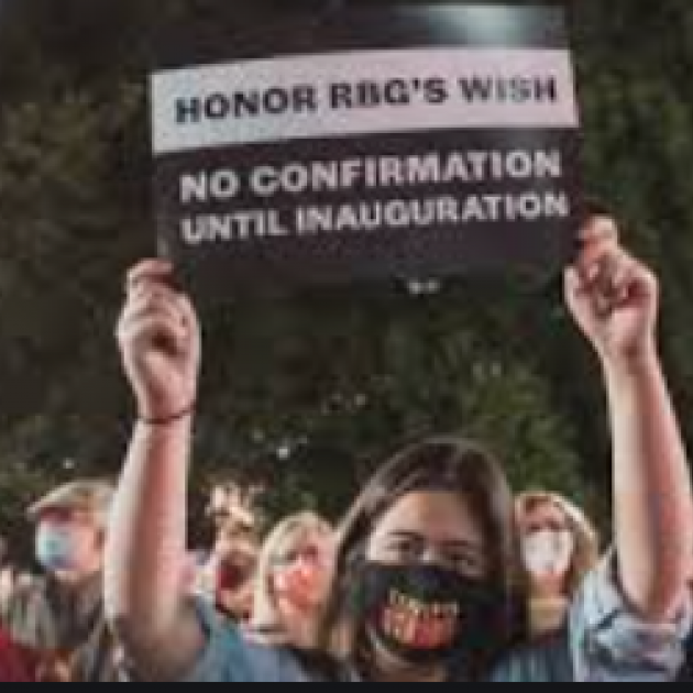 Man holding sign saying Honor RBG's wish