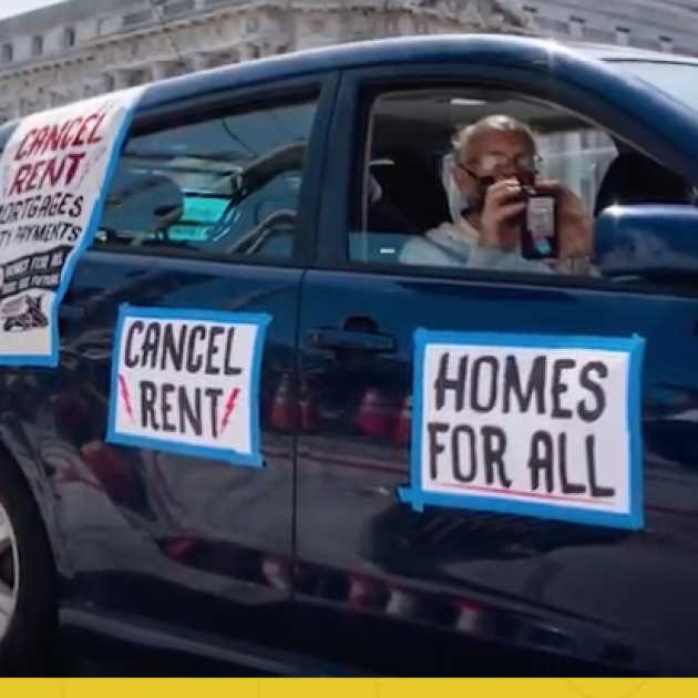 Person in car in caravan with sign Homes for All