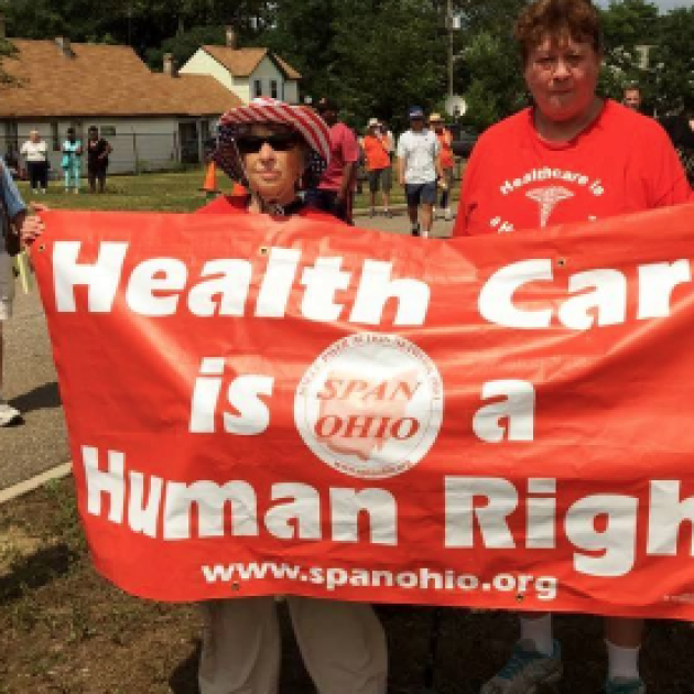 People holding banner that says Health Care is a Human Right