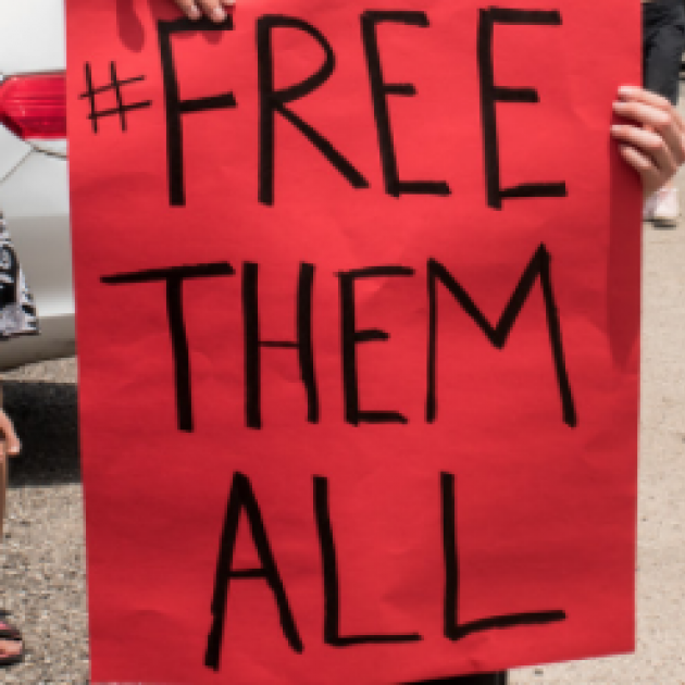 Sign saying Free Them All