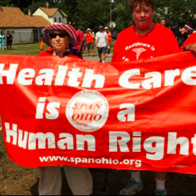 People holding banner saying Health Care is a Human Right