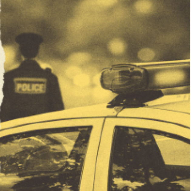 Cop standing by car