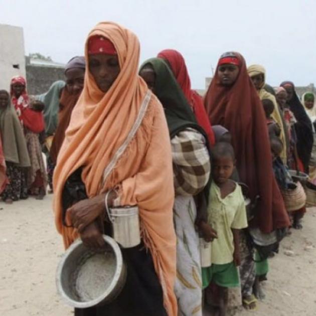 Somalian women in Somalia wearing headresses standing in line waiting for food