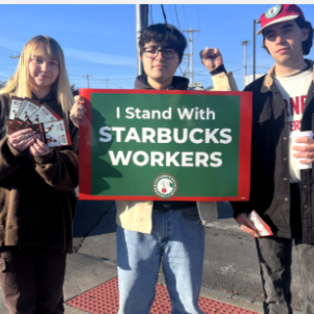 Three young people standing with sign saying I stand with Starbucks workers