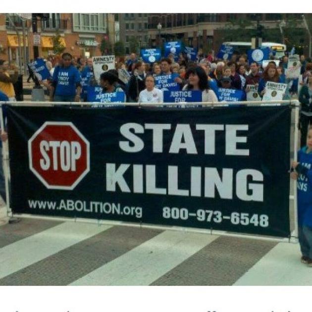 People marching with sign Stop State Killing