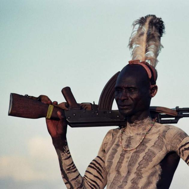 Photos of indigenous man with rifle 