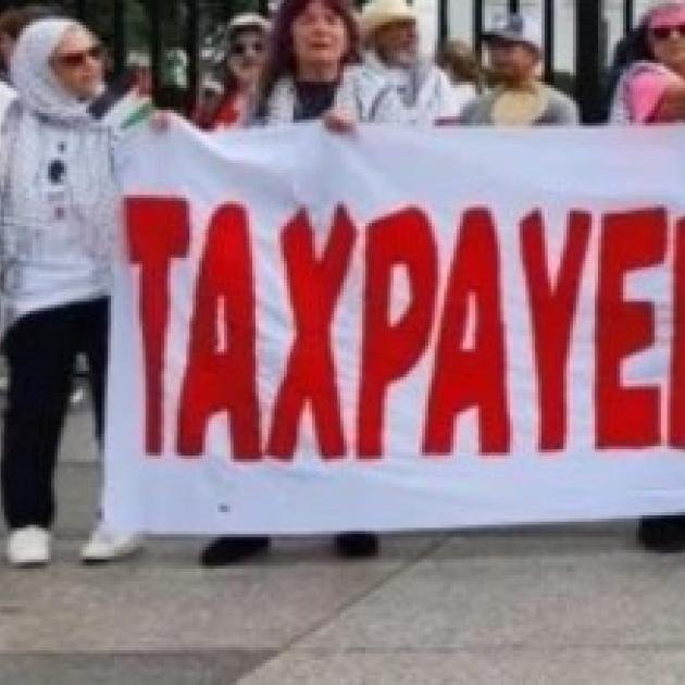 People holding Taxpayers Aganst Genocide banner
