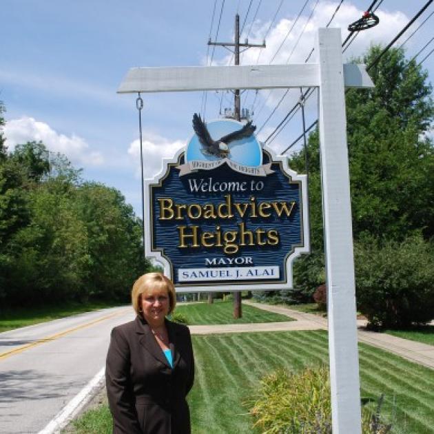 Blonde woman next to the Broadview Hts sign