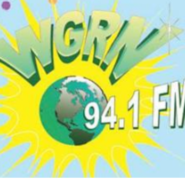 Letters WGRN and 94.1FM with a earth and a yellow splash behind it over light blue
