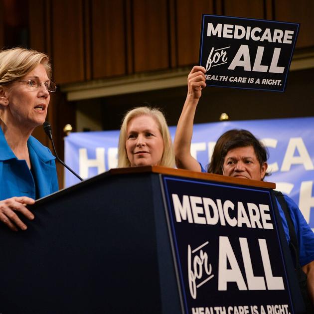 Elizabeth Wareen speaking at podium about Medicare for All