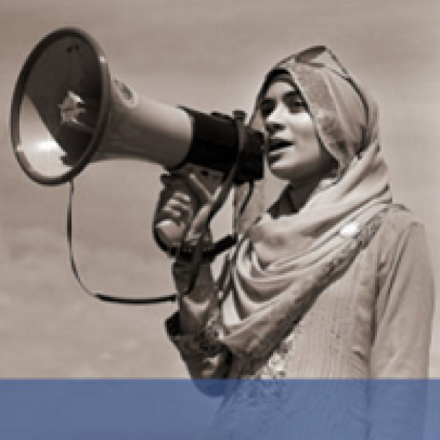 Woman in hijab talking into a megaphone