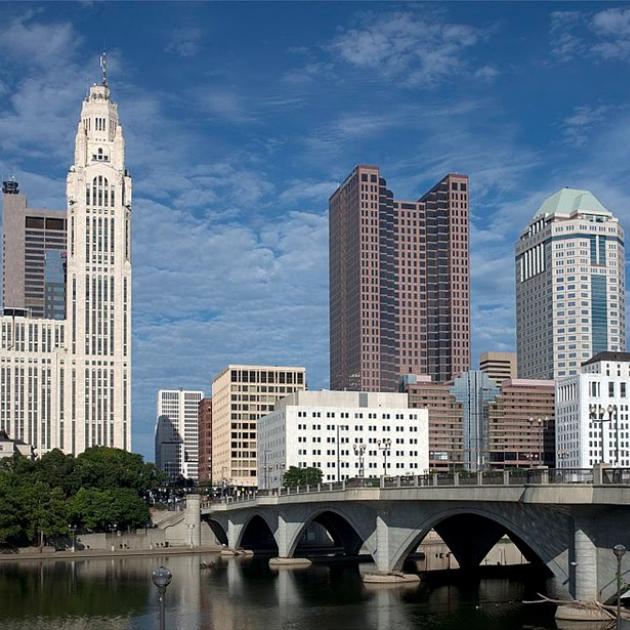 Tall buildings and riverfront scene with blue sky