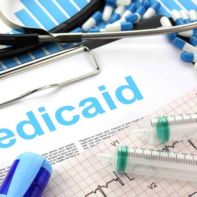 Syringes and pills and word Medicaid