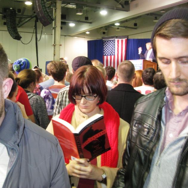 Kyle Landis, Hayley Cotter, and Jordan Patton catch up on their reading while Donald Trump speaks at the Greater Columbus Convention Center.
