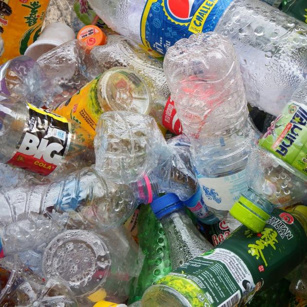 Colorful photo of empty plastic bottles all lying on top of each other in a heap