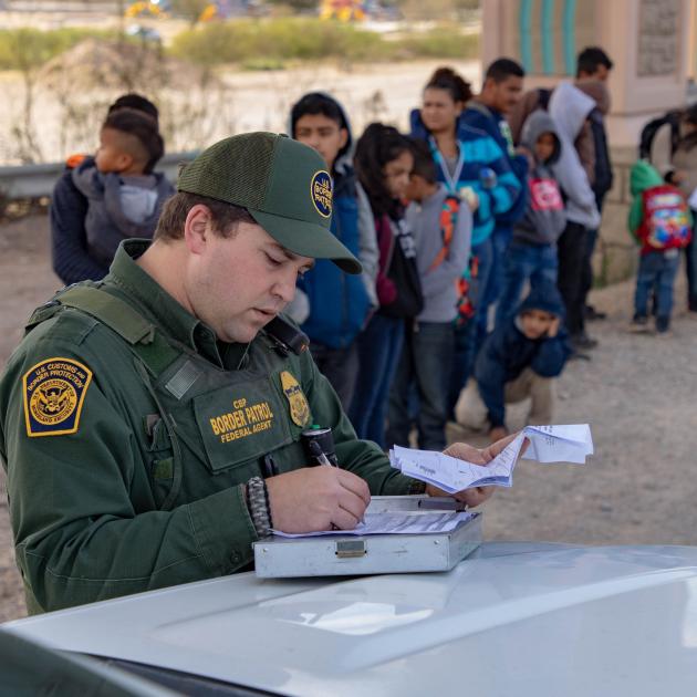 Border patrol and line of immigrants
