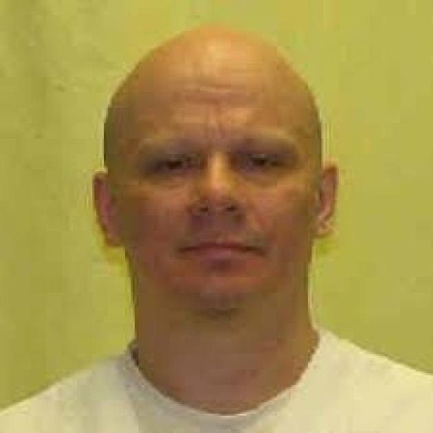 Head shot of white man in white shirt with bald head