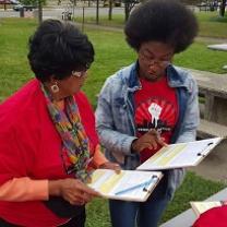 Two black women discussing registering to vote