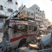 White and red ambulance all blown up with debris all around