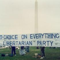 A long sign saying Pro choice on everything Libertarian Party held outside in front of the Washington monument