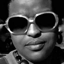 Black woman's face close up, wearing large sunglasses