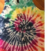 Sleeveless T-shirt with colorful tie-dye pattern in a spiral and the words Pro choice AF