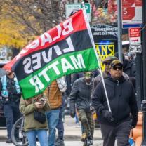 Marcher with Black Lives Matter flag