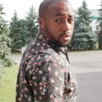 Black man turning to look behind him 