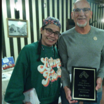 Woman and man with award