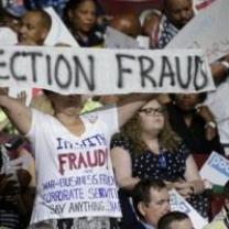 Bernie delegates holding up Election Fraud sign at DNC