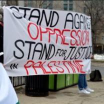 A big sign on a sheet saying Stand Against Oppression Stand for Justice for Palestine